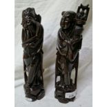 A pair of Oriental imortals carved in rootwood, inlaid.