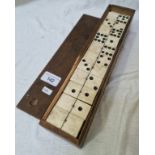A set of bone and ebony double nine dominoes in wooden box.