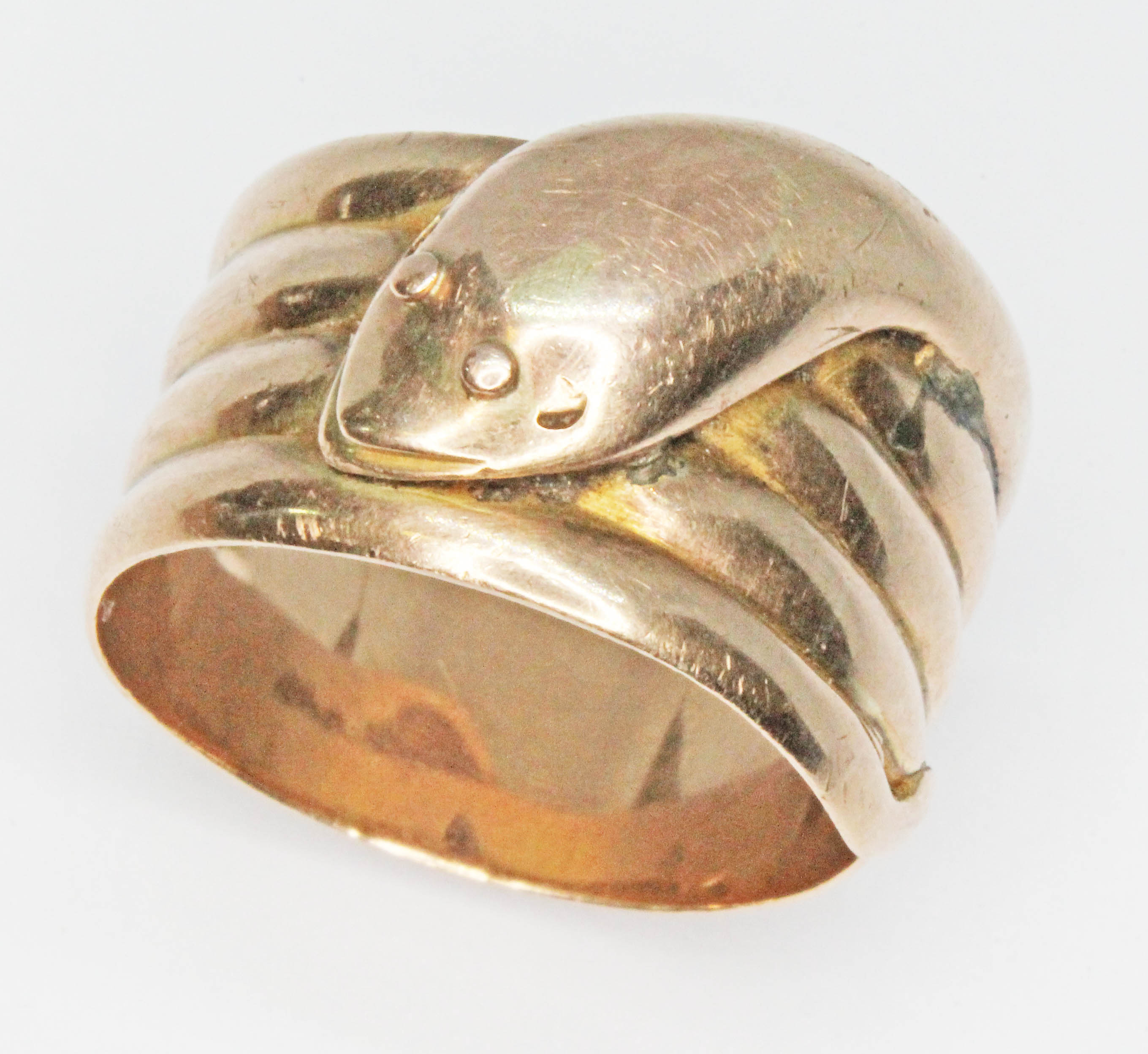 A 9ct gold ring formed as a coiled snake, hallmarked 9ct gold, sponsor mark indistinct, Birmingham