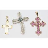 A group of three crucifix pendants comprising one set with a single diamond, the bale marked '585'
