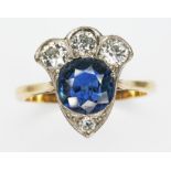 A diamond and sapphire cluster ring, the central round cut sapphire weighing approx. 1.23cts, four