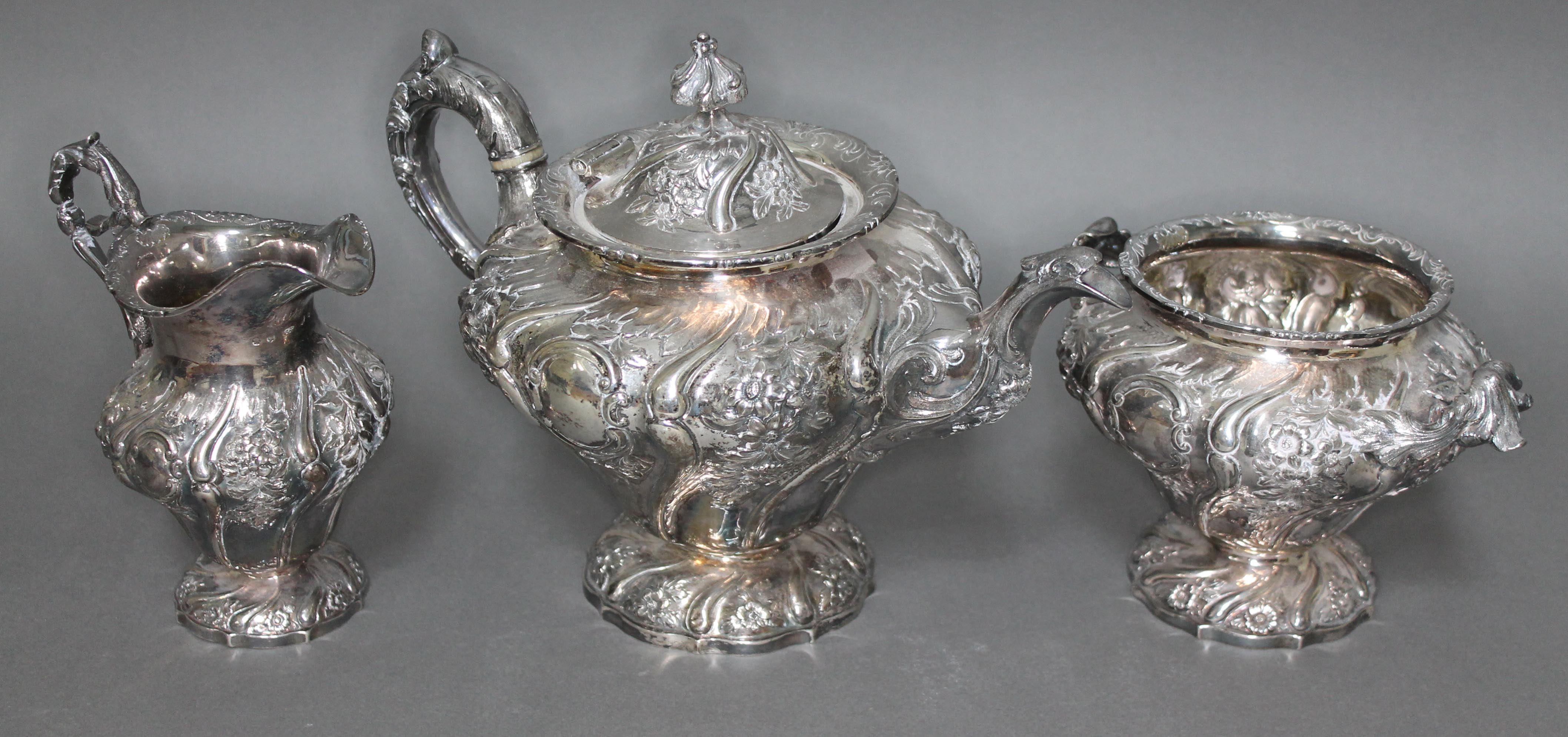 A William IV Scottish silver tea set, repousse decoration depicting floral bouquets and scrolls, - Image 4 of 4