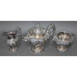 A William IV Scottish silver tea set, repousse decoration depicting floral bouquets and scrolls,