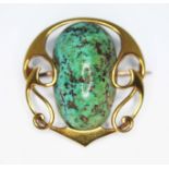 An Art Nouveau brooch in the manner of Archibald Knox/Liberty & Co, set with a large turquoise