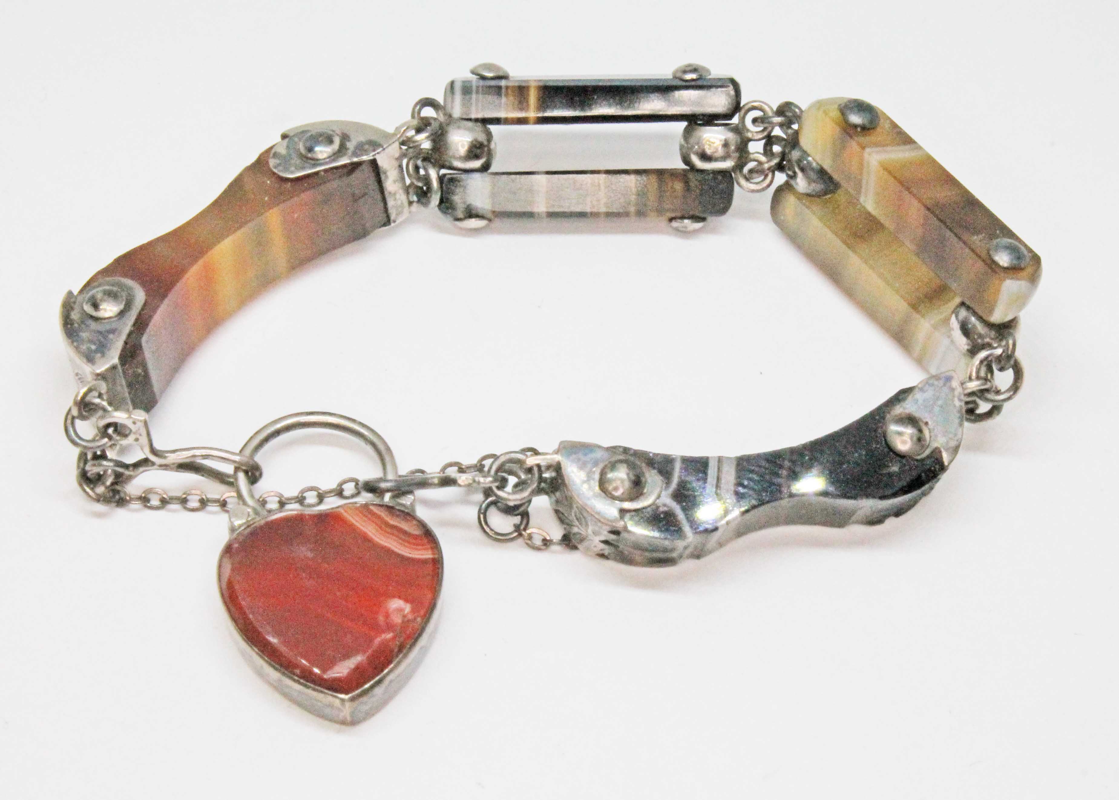 A Victorian white metal sardonyx and agate bracelet with heart shaped padlock clasp, length 14cm,