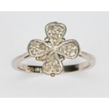 A diamond four leaf cluster ring, the cluster diameter approx. 11mm, band marked '18ct', gross wt.