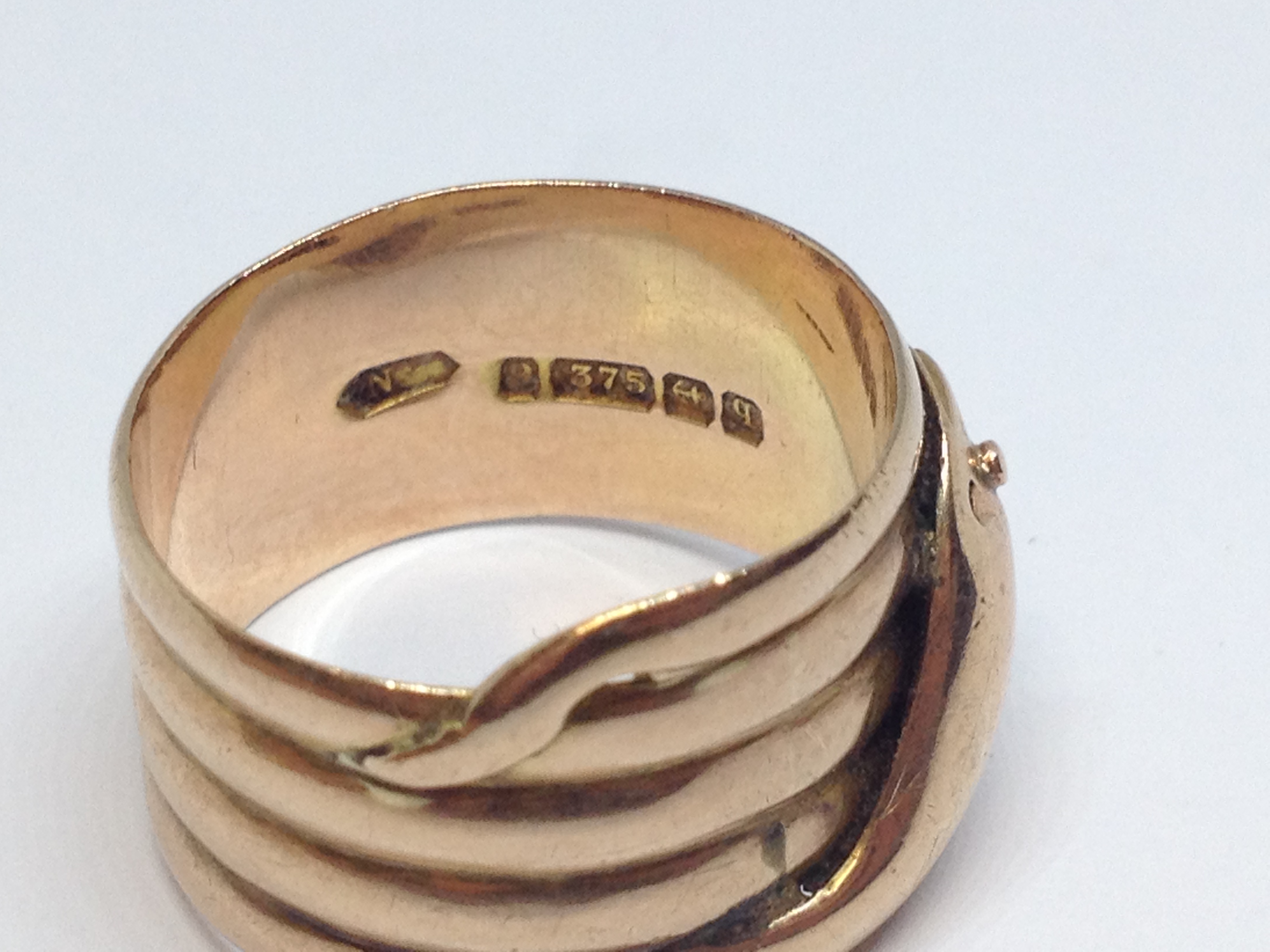 A 9ct gold ring formed as a coiled snake, hallmarked 9ct gold, sponsor mark indistinct, Birmingham - Image 2 of 4