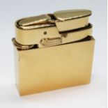 A Fred Manshaw textured gold cased gas lighter, marked 'FM' within a heart and '9.375', gold wt.