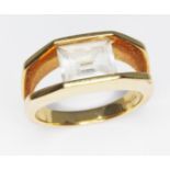 A channel set colourless topaz solitaire ring, marked '750', gross wt. 7.7g, size O.