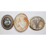 A group of three brooches comprising a one set with a pietra dura inlaid slab, a shell cameo