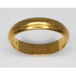 A hallmarked 22ct gold wedding band, wt. 3.8g, size M.