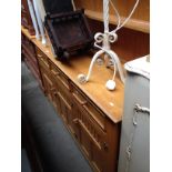 A light oak dresser with plate rack back, width 158cm.