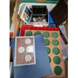A box of coin collector's items -empty cases and a few coins/tokens