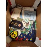 A box of ephemera, postcards and assorted military badges etc.