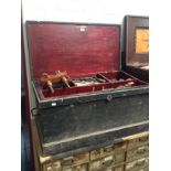 An antique joiner's toolbox with fitted interior containing a number of vintage woodworking tools,