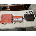 Two Radley handbags with sleeves and a Barbour leather handbag.