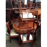 A Chinese carved hardwood extending dining table and six chairs,
