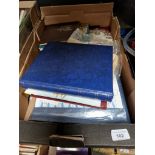 A box of assorted stamp albums