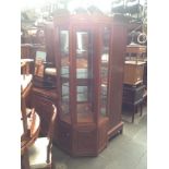 A Chinese carved hardwood corner display cabinet.