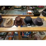 Three trilby hats and a bowler hat, all by Dunn & Co, together with a fox fur coat