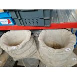 A pair of concrete sack planters