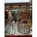 An ornamental metal bird cage on a stand