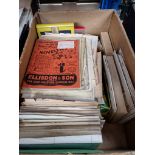 A box of vintage magic tricks and various magic ephemera.