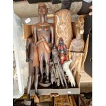 A box of tribal figures, wood carvings, and two silver plated birds