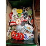 A box of vintage pin badges