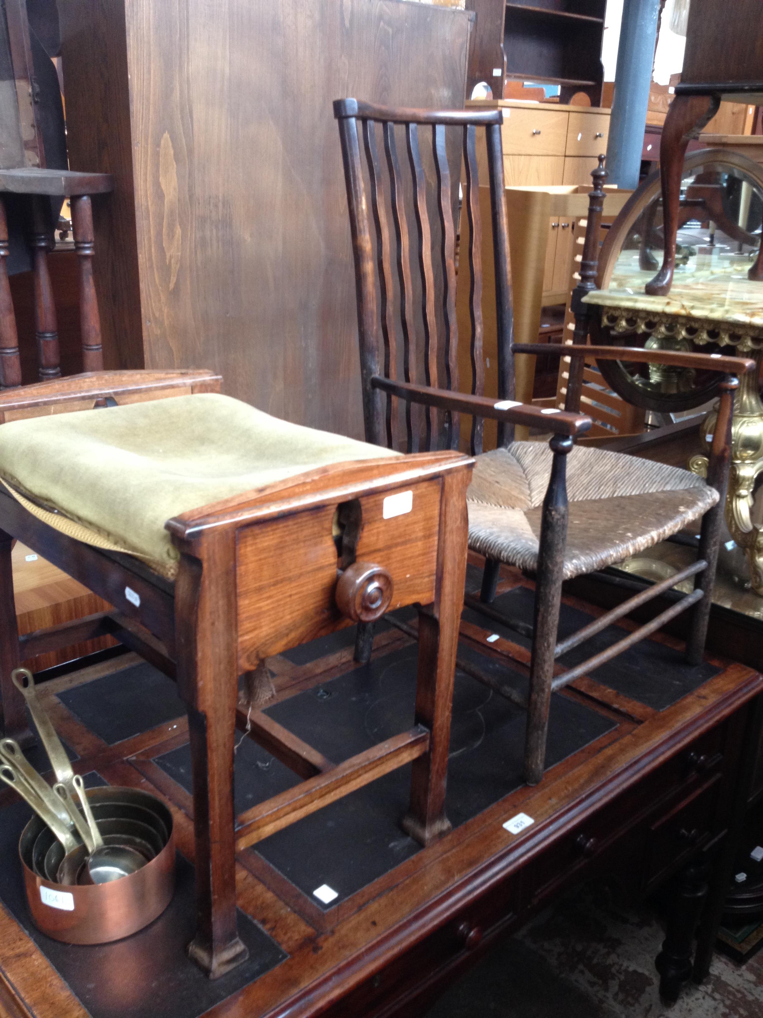 An Arts & Crafts ebonised and rush seat chair together with an Edwardian adjustable piano stool.