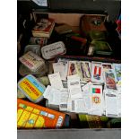 A box of vintage tins and a tin of vintage cigarette cards