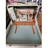 A vintage mid 20th century Singer sewing machine, model 216-G, circa 1954 with pedal and accessories