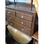 A Victorian pine chest of drawers with glass handles together with an oak drop leaf table.