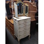 A French style painted chest of drawers together with a triple mirror.