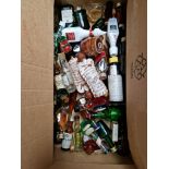 A box of miniature alcoholic beverages including whisky and brandy