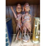 A pair of African carved wood figures, height 45cm.