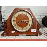 A 1930s Art Deco walnut cased mantle clock, complete with pendulum and key.