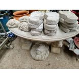 A concrete garden bench, crescent shape on squirrel plinths