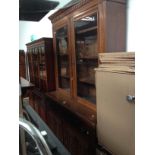 An Edwardian oak cabinet bookcase with carved panels to the doors, width 157cm, depth 50cm &