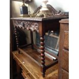 A late Victorian carved oak side table with 'Green Man' detail, width 92cm.