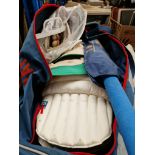 A Gray Nicholls bag of adult cricket equipment including batting and wicket keeping gloves, hat,