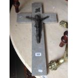A vintage cast metal and stoneware crucifix.