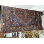 A vintage Middle Eastern hand knotted wool carpet, blue ground, 190cm x 160cm (approx).
