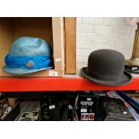 A bowler hat by G.A. Dunn & Co together with a vintage ladies hat and a pair of leather gloves.