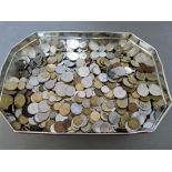 A tin of assorted world coins.