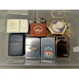 A tub containing 5 assorted Zippo lighters and 2 others