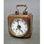 A small German brass alarm clock.