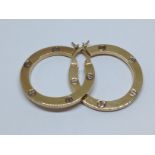 A pair of hallmarked 9ct gold Cartier style earrings, diameter 27mm, wt. 3.6g.