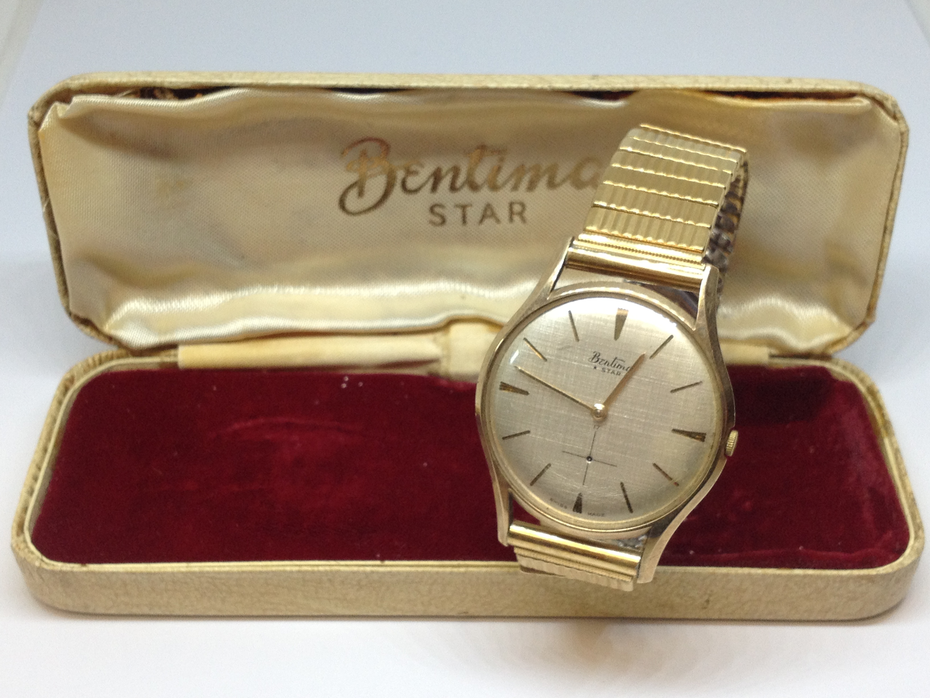 A 9ct gold Bentima star wristwatch, flexi gold plated strap, as found.