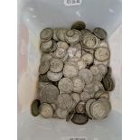 A tub of assorted silver coins, mostly UK, some pre 1920.